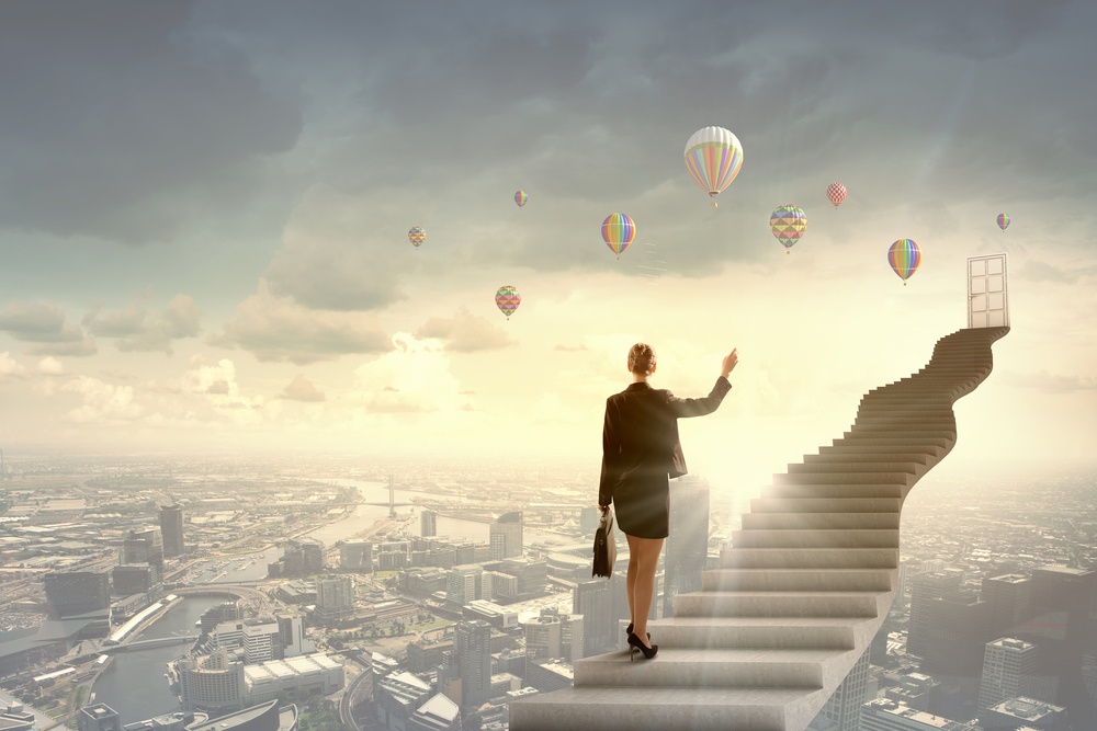 Businesswoman walking up staircase to door in sky-1