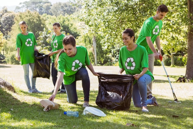 Environmental activists picking up trash on a sunny day.jpeg