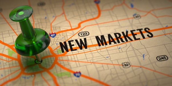 New Markets Concept - Green Pushpin on a Map Background with Selective Focus..jpeg
