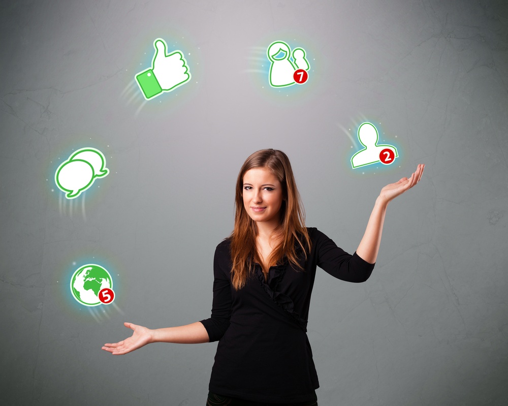 attractive young woman standing and juggling with social network icons.jpeg